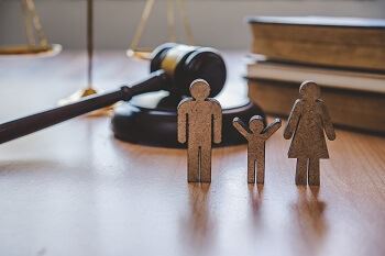 Figures Representing Family in Courtroom