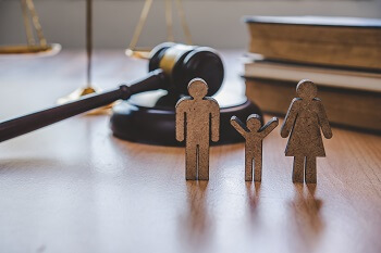 Figures Representing Family in Courtroom