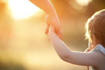 Guardian Holding Child's Hand